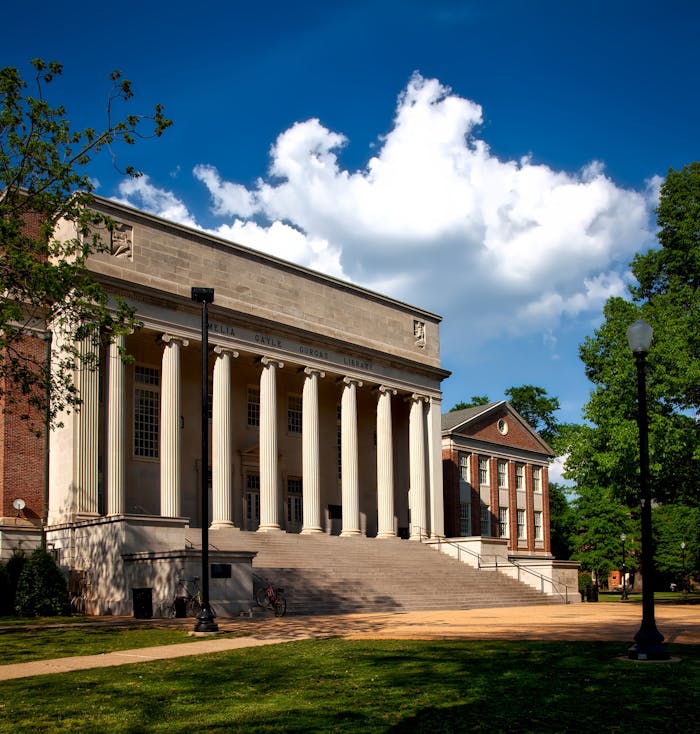 Historic neoclassical university library with columns on a sunny day.